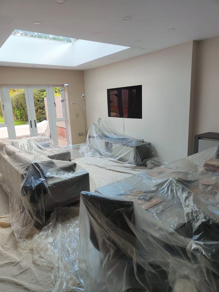 Open-plan living space fully protected before decorating works