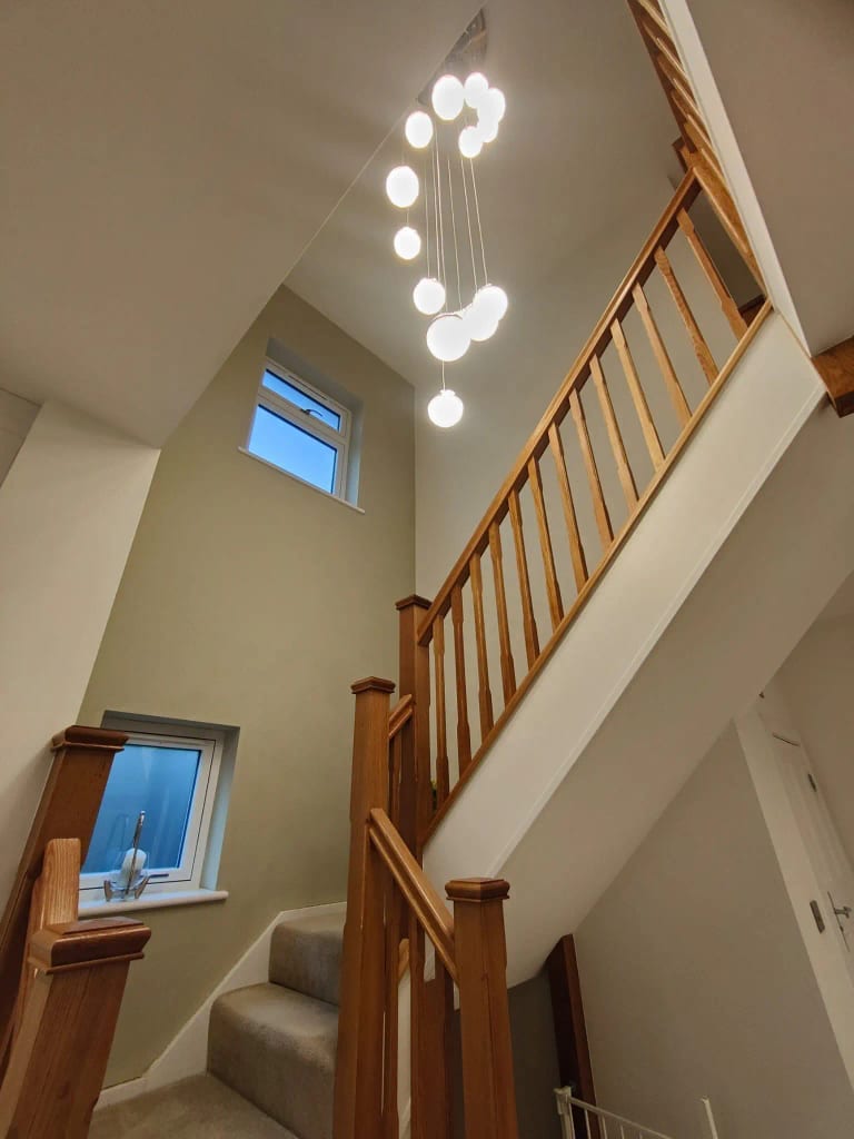 Painted staircase balustrade with timber handrail